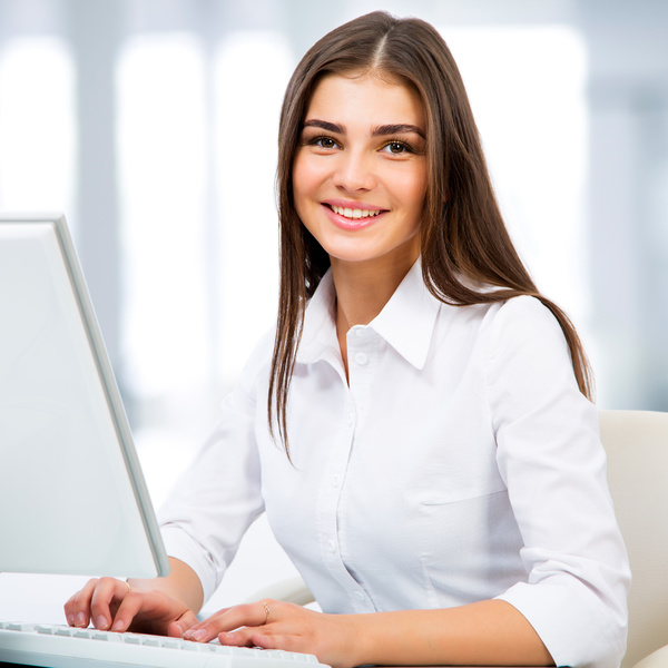 Portrait of a young businesswoman using computer at office